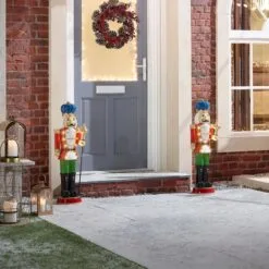 Noel The 3ft Red Christmas Nutcracker With Staff 23 Noel The 3ft Red Christmas Nutcracker With Staff -Twinkly Shop w18527 outdoor lifestyle shot 5